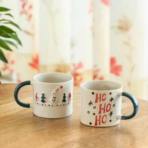 ExclusiveLane 'Christmas Charm' Ceramic Tea And Coffee Mugs (Set of 2, 330 ML, Microwave Safe, Hand-Embossed) ExclusiveLane 'Christmas Charm' Ceramic Tea And Coffee Mugs (Set of 2, 330 ML, Microwave Safe, Hand-Embossed)