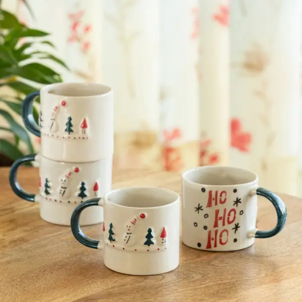 ExclusiveLane 'Christmas Charm' Ceramic Tea And Coffee Mugs (Set of 4, 330 ML, Microwave Safe, Hand-Embossed) ExclusiveLane 'Christmas Charm' Ceramic Tea And Coffee Mugs (Set of 4, 330 ML, Microwave Safe, Hand-Embossed)