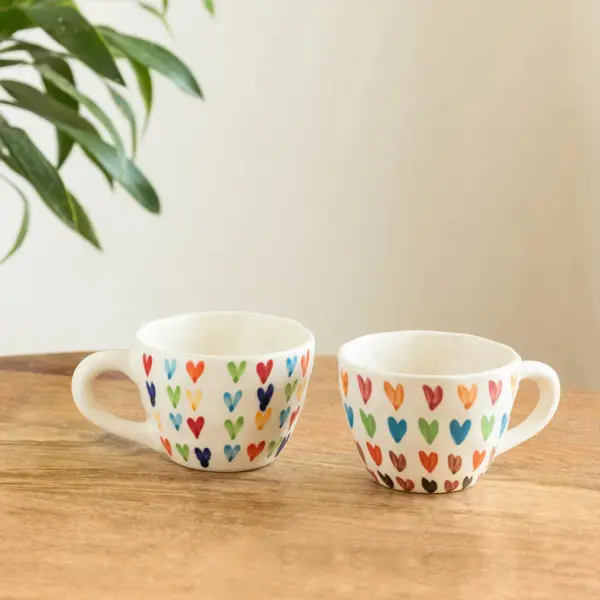 ExclusiveLane 'Colourfull Hearts' Ceramic Tea And Coffee Mugs (Set of 2, 270 ML, Microwave Safe, Hand-Painted) ExclusiveLane 'Colourfull Hearts' Ceramic Tea And Coffee Mugs (Set of 2, 270 ML, Microwave Safe, Hand-Painted)