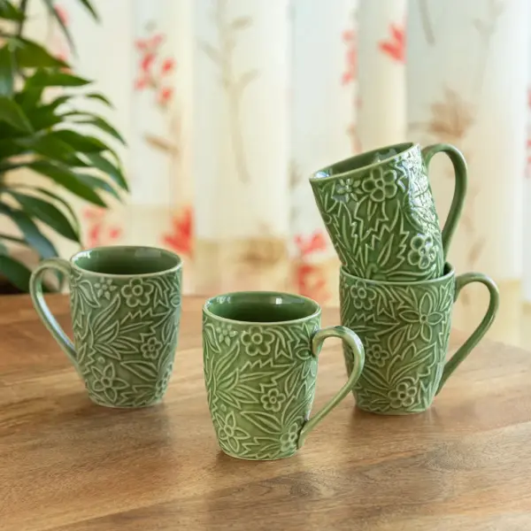 ExclusiveLane 'Green Flora' Ceramic Tea And Coffee Mugs (Set of 4, 290 ML, Microwave Safe, Hand-Embossed) ExclusiveLane 'Green Flora' Ceramic Tea And Coffee Mugs (Set of 4, 290 ML, Microwave Safe, Hand-Embossed)