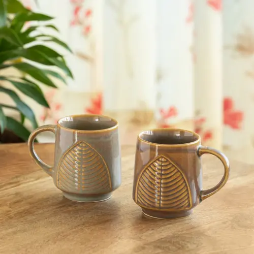 ExclusiveLane 'Leaf & Lines' Ceramic Tea And Coffee Mugs (Set of 2, 300 ML, Microwave Safe, Hand-Embossed) ExclusiveLane 'Leaf & Lines' Ceramic Tea And Coffee Mugs (Set of 2, 300 ML, Microwave Safe, Hand-Embossed)