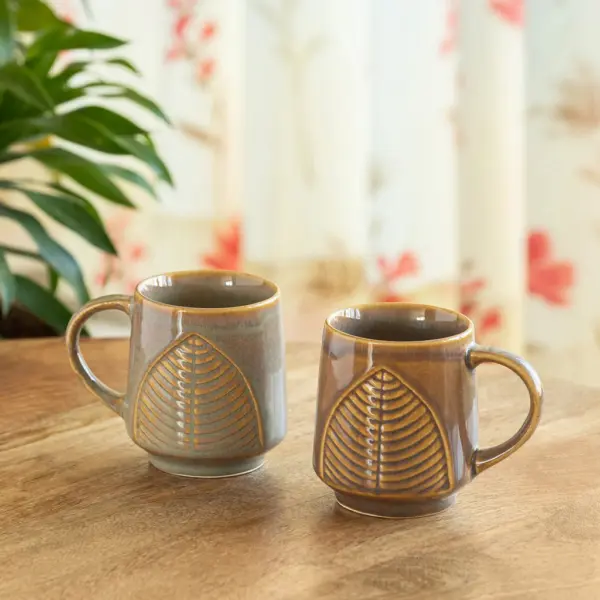 ExclusiveLane 'Leaf & Lines' Ceramic Tea And Coffee Mugs (Set of 2, 300 ML, Microwave Safe, Hand-Embossed) ExclusiveLane 'Leaf & Lines' Ceramic Tea And Coffee Mugs (Set of 2, 300 ML, Microwave Safe, Hand-Embossed)
