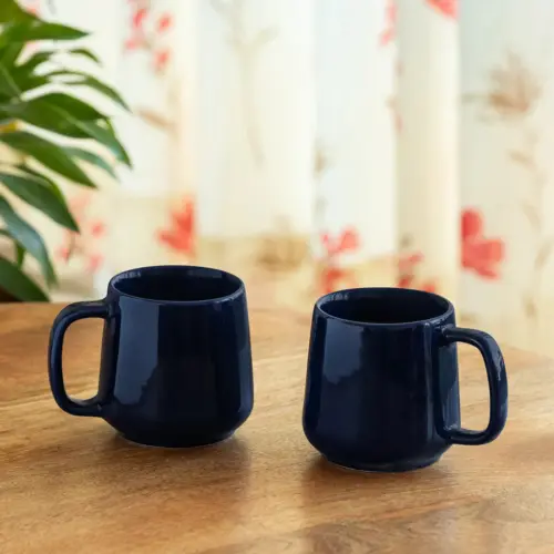 ExclusiveLane 'Mariana Blues' Ceramic Tea & Coffee Mugs (Set of 2, 340 ML, Microwave Safe, Hand Glazed) ExclusiveLane 'Mariana Blues' Ceramic Tea & Coffee Mugs (Set of 2, 340 ML, Microwave Safe, Hand Glazed)