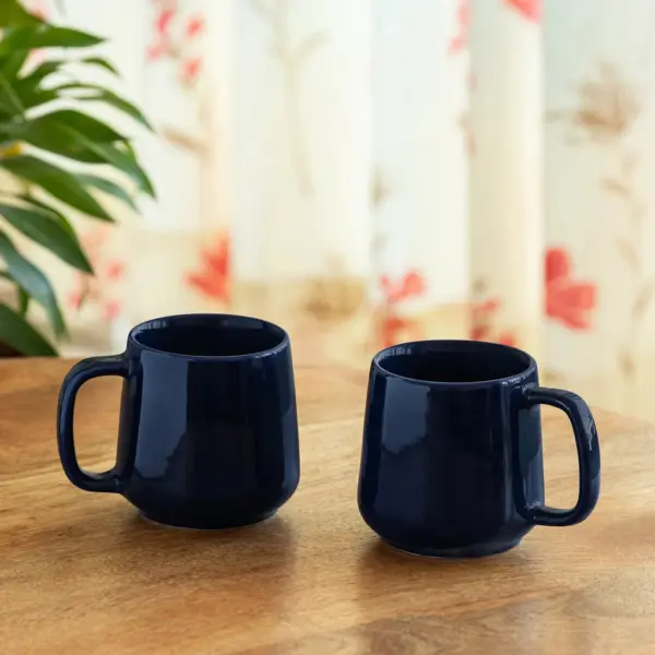 ExclusiveLane 'Mariana Blues' Ceramic Tea & Coffee Mugs (Set of 2, 340 ML, Microwave Safe, Hand Glazed) ExclusiveLane 'Mariana Blues' Ceramic Tea & Coffee Mugs (Set of 2, 340 ML, Microwave Safe, Hand Glazed)
